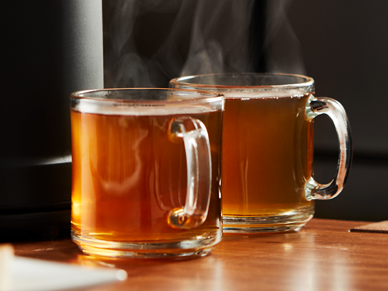 Two steaming mugs of warm winter cocktails 