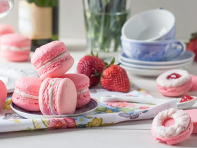 A plate of strawberry rose macarons.