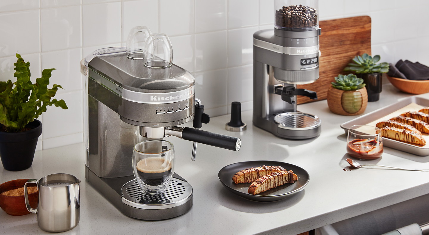 KitchenAid® espresso maker next to homemade biscotti