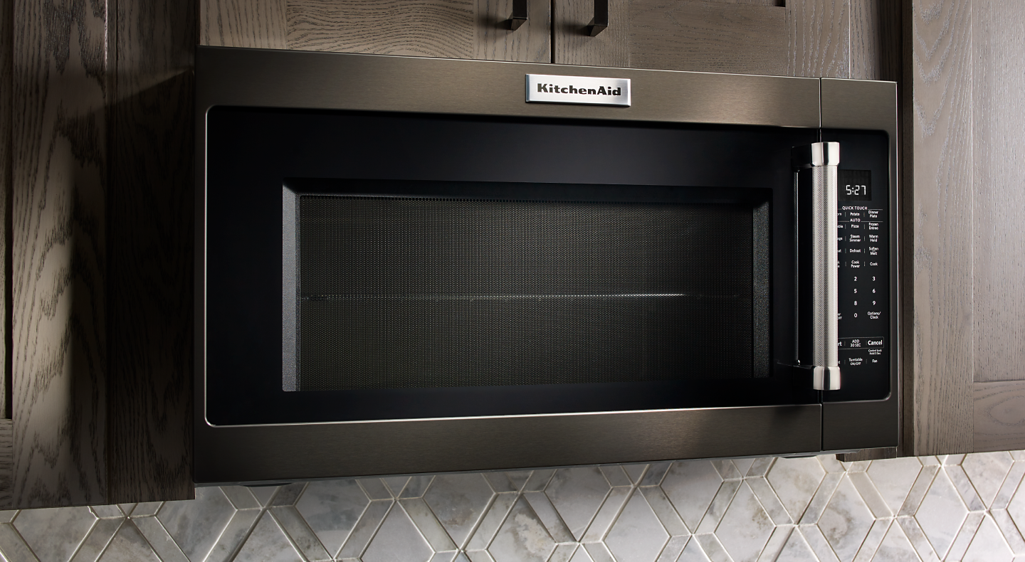 A black and silver KitchenAid® microwave in a kitchen