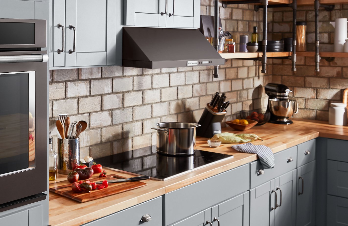 Pot resting on cooktop with sliced vegetables to the side Pot resting on cooktop with sliced vegetables to the side