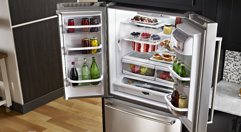 Open French door refrigerator stocked with food and drinks
