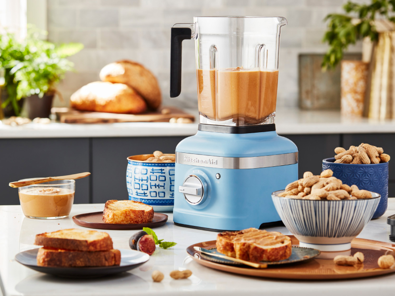 A KitchenAid® blender with blended nut butter on a modern kitchen counter.