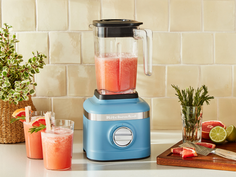 A KitchenAid® blender with a smoothie mixture on a modern kitchen counter.