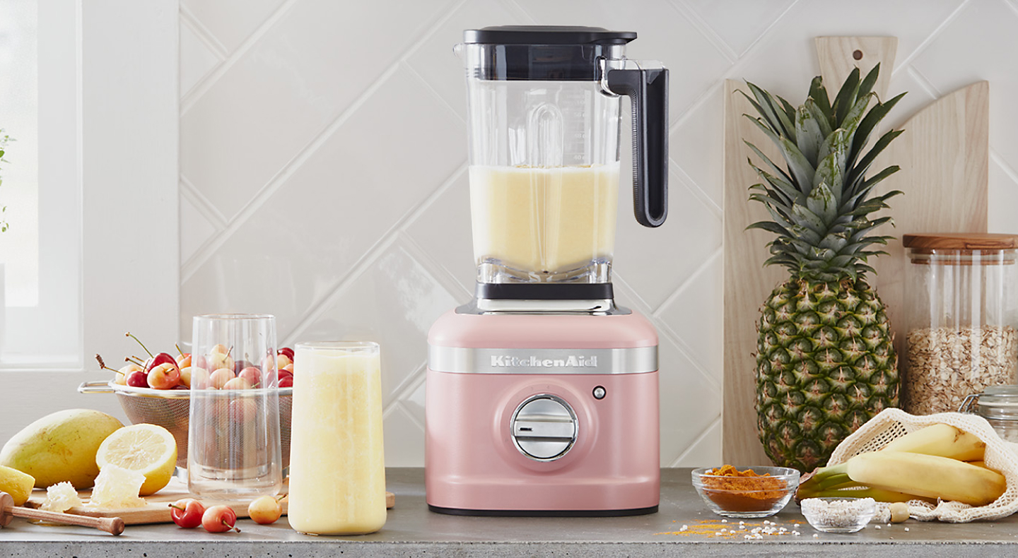 A KitchenAid® blender with a freshly made smoothie on a modern kitchen counter.