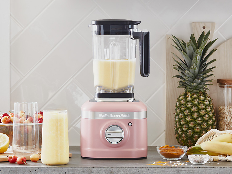 A KitchenAid® blender with a freshly made smoothie on a modern kitchen counter.