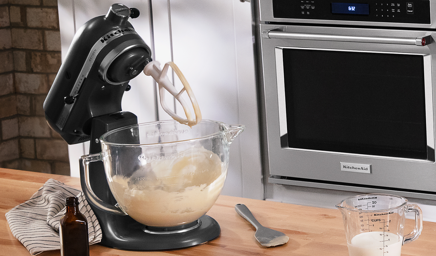 Black KitchenAid® stand mixer with Flat Beater Accessory and ingredients next to it