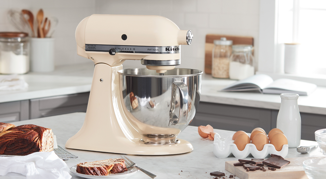 A beige KitchenAid® stand mixer next to baking ingredients.
