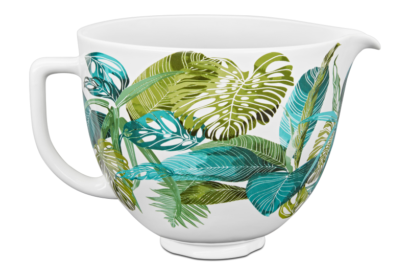 A mixing bowl with a green and blue leaf design.