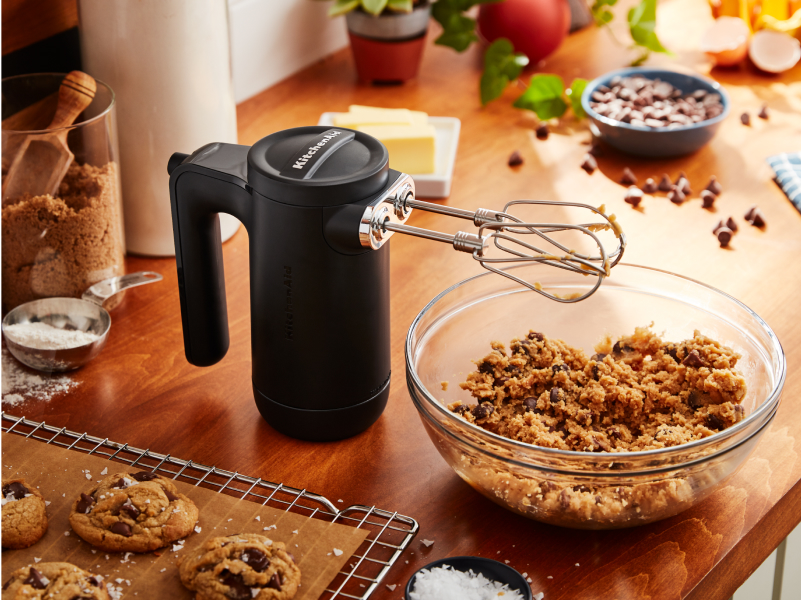 A KitchenAid® cordless hand mixer and baking ingredients.