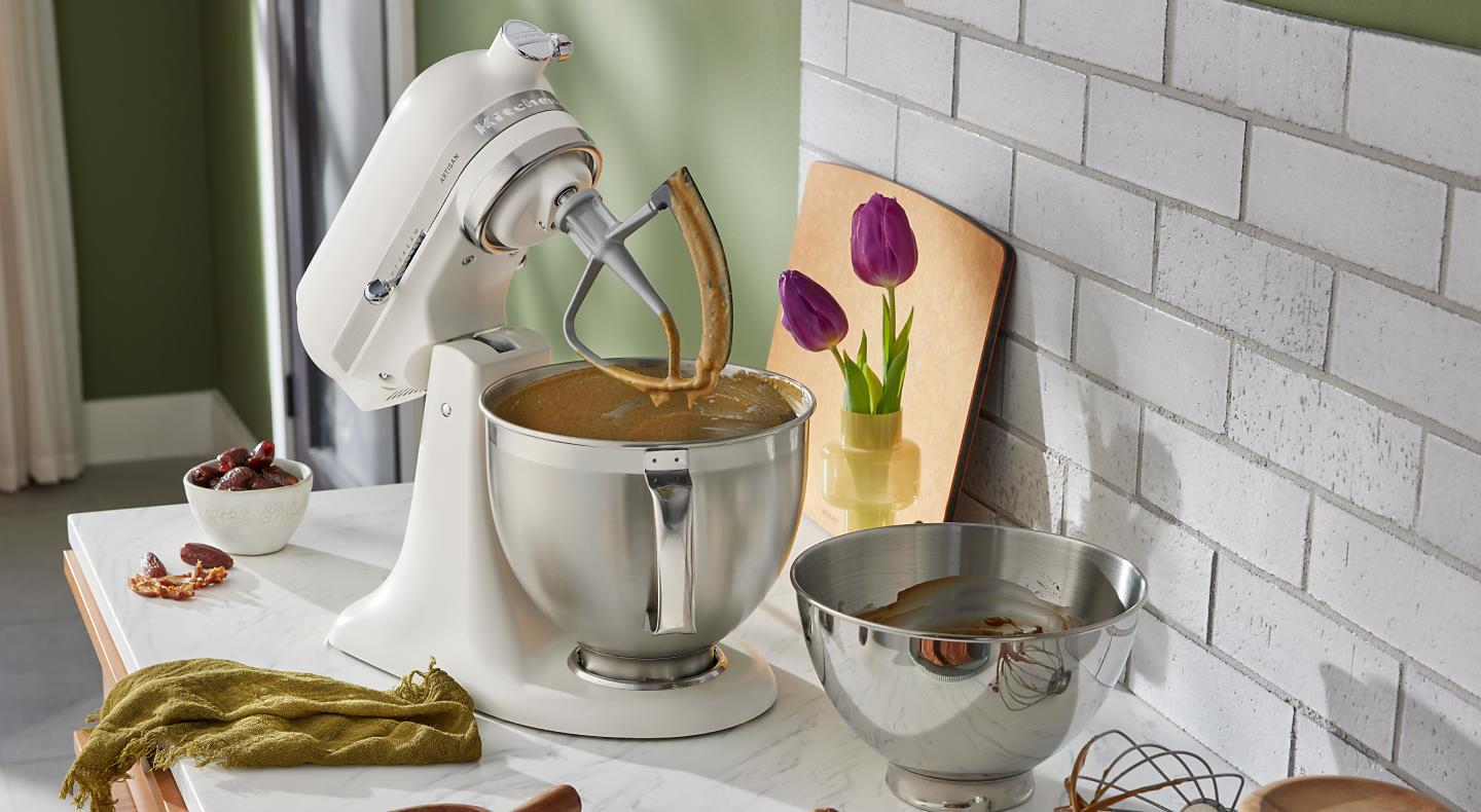 A white stand mixer with an attachment