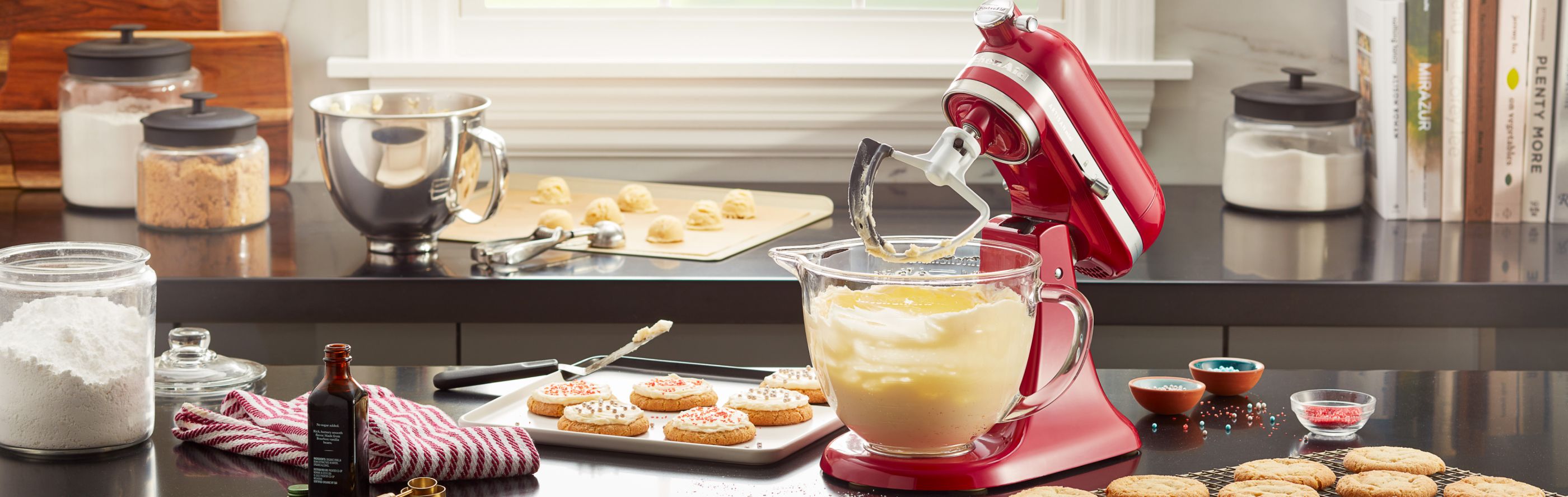A red KitchenAid® stand mixer used to make cookie batter