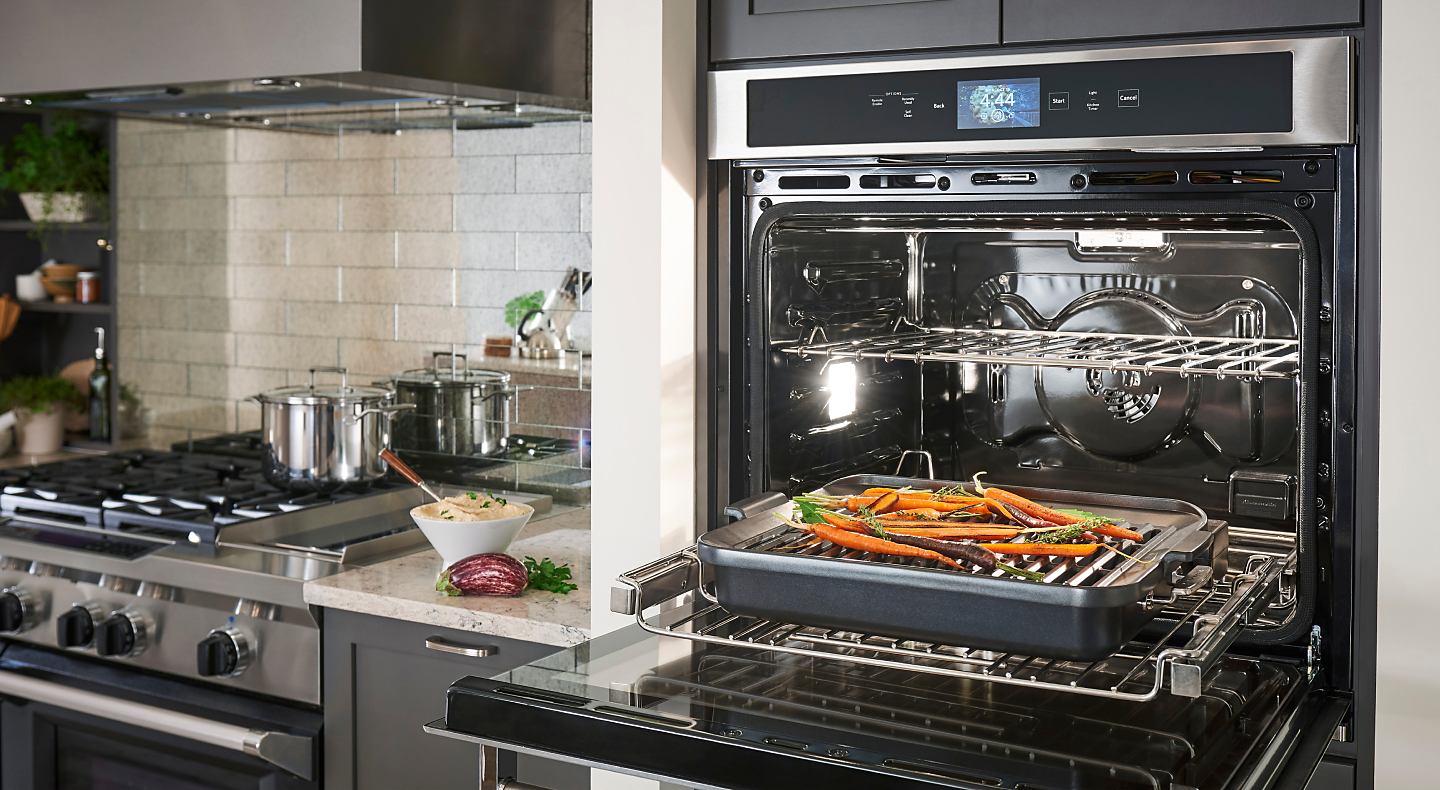 KitchenAid® Smart Oven+ with door open to reveal carrots on Grilling Attachment
