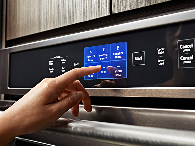 Maker adjusting settings on KitchenAid® Smart Oven+ control panel