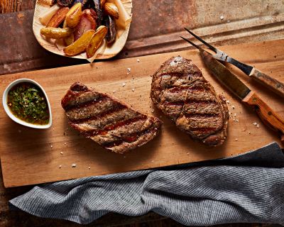 Grilled filets of steak on a serving board
