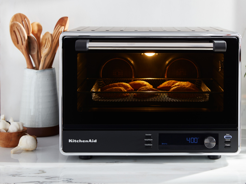 A KitchenAid® countertop oven with air fry on a modern kitchen counter. 