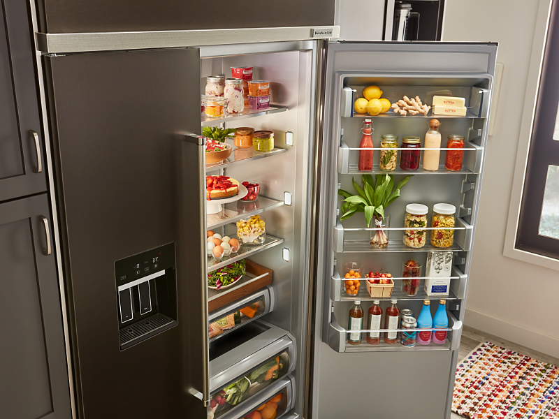 An open refrigerator door where food items are being stored