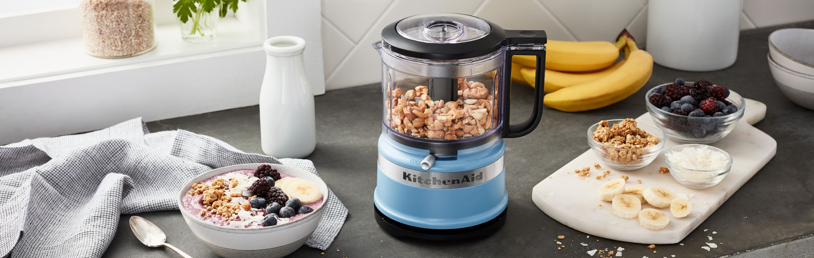 A KitchenAid® food processor with ground almonds and ground-almond dish