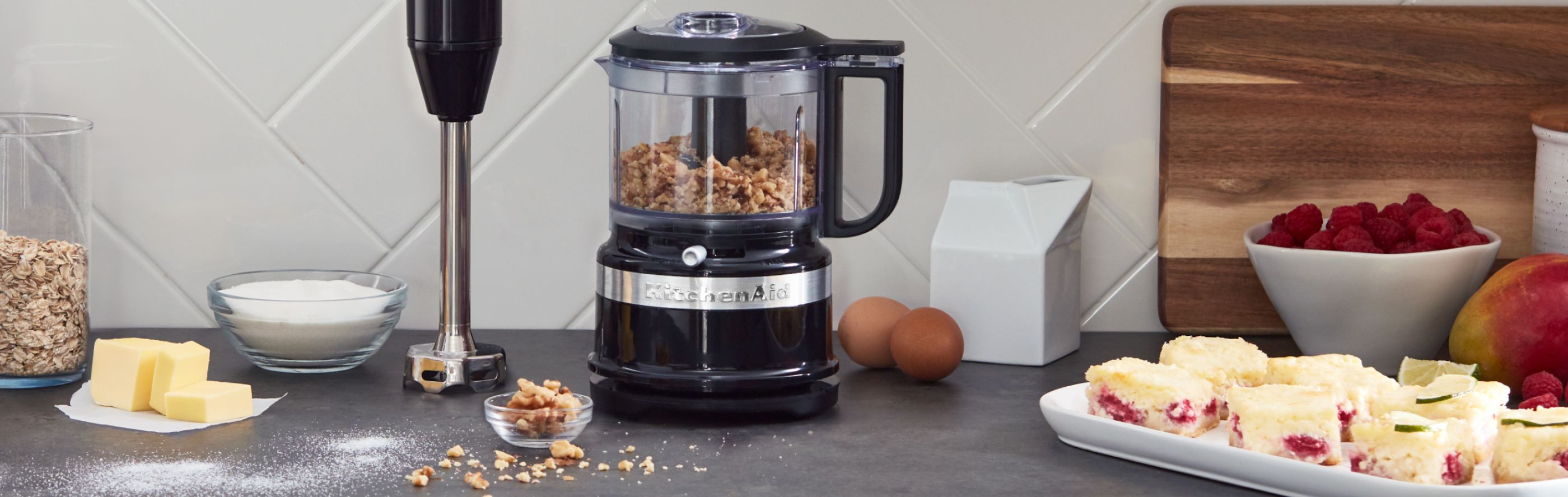 A KitchenAid® food processor and immersion blender on a countertop