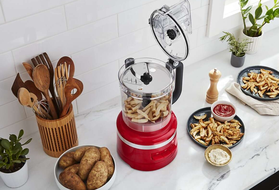 KitchenAid® Food Processor with sliced potatoes on a counter 