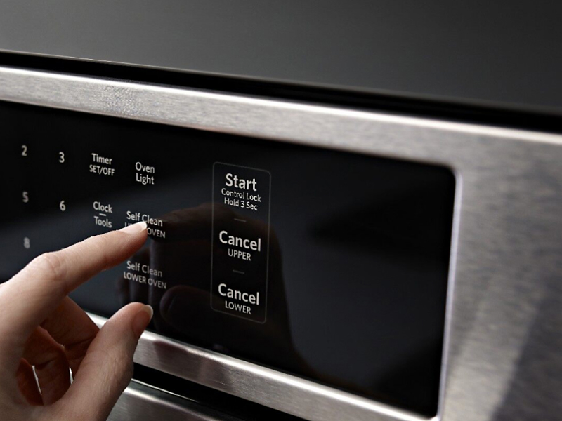 Person selecting a setting on a KitchenAid® oven