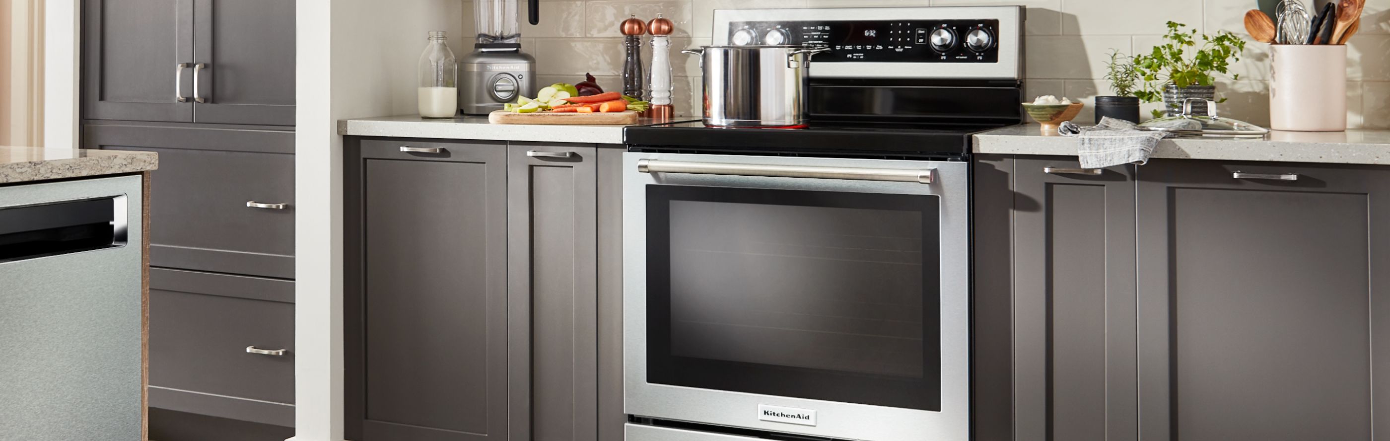 Stainless steel range in a kitchen with dark cabinets