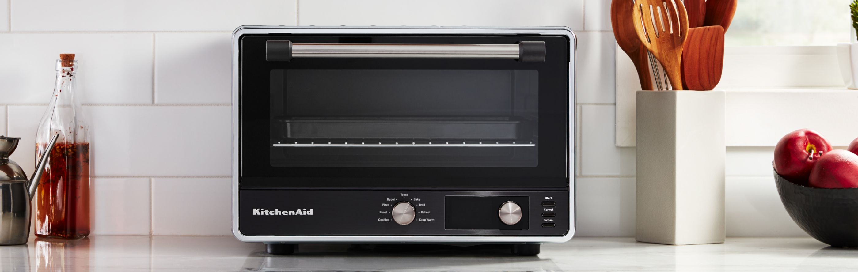 A KitchenAid® countertop oven on a white countertop