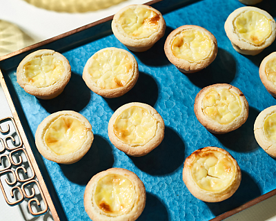 Sweet cheese tarts on blue serving tray