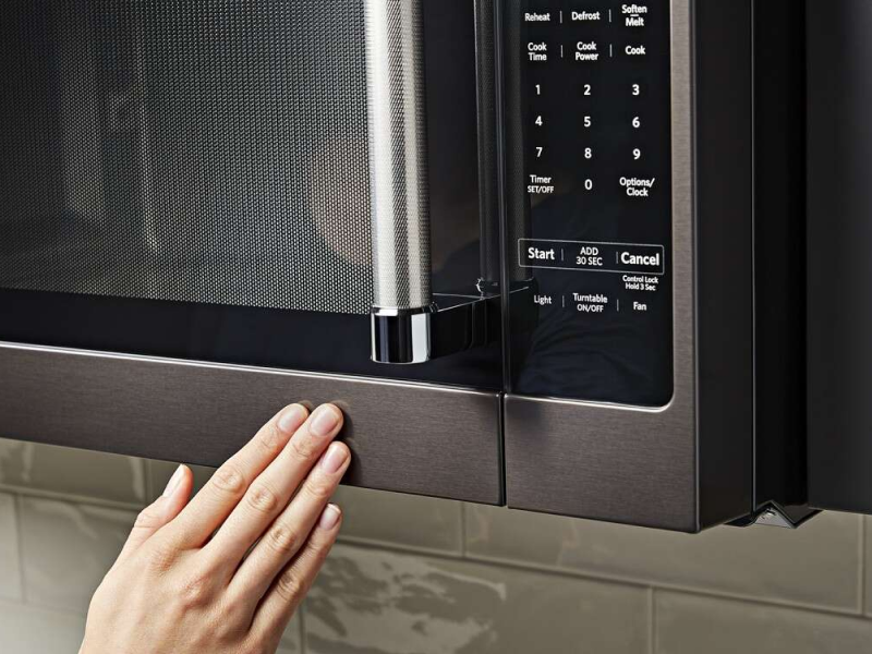 Person closing a microwave door