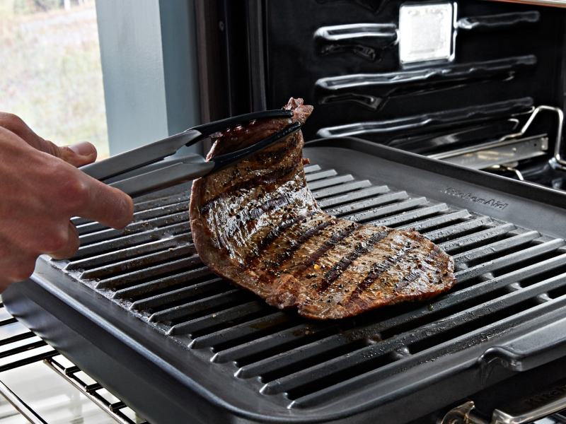 Steak being grilled inside an oven