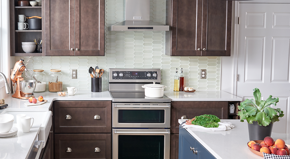 KitchenAid® range hood and double oven in a bright kitchen