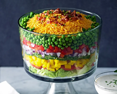 Layered veggie salad in glass bowl from Yummly recipe