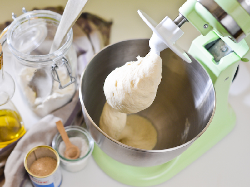 Dough being mixed with a dough hook in stand mixer bowl