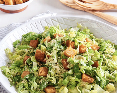 A homemade Caesar salad topped with croutons.