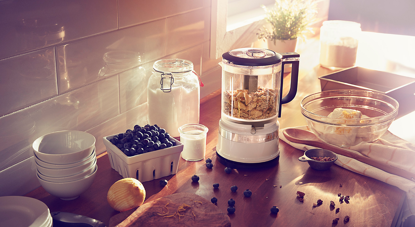 KitchenAid® food chopper on countertop with blueberries and cream cheese