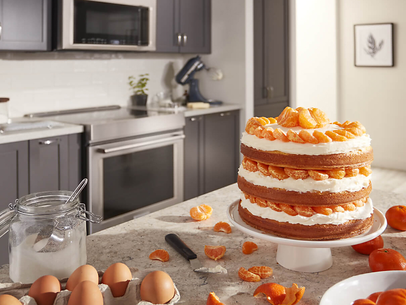 Three layer orange cake on a counter