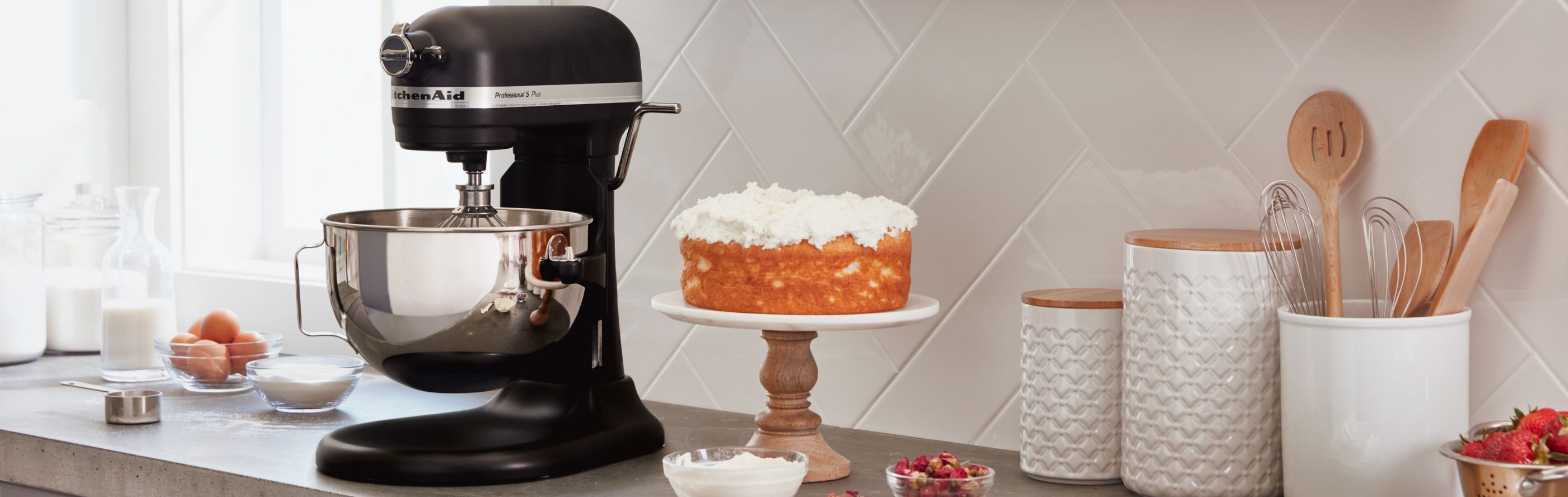 KitchenAid® bowl lift stand mixer with finished cake next to it.