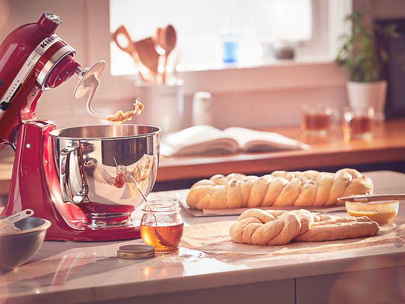 Challah on a counter next to a KitchenAid® stand mixer