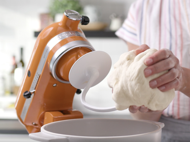 Person taking dough off of dough hook
