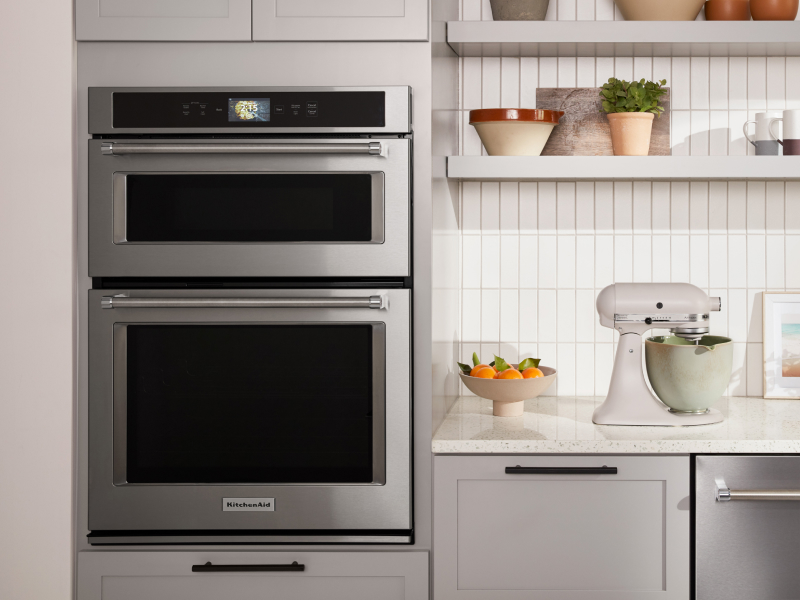A KitchenAid® double oven next to a white stand mixer