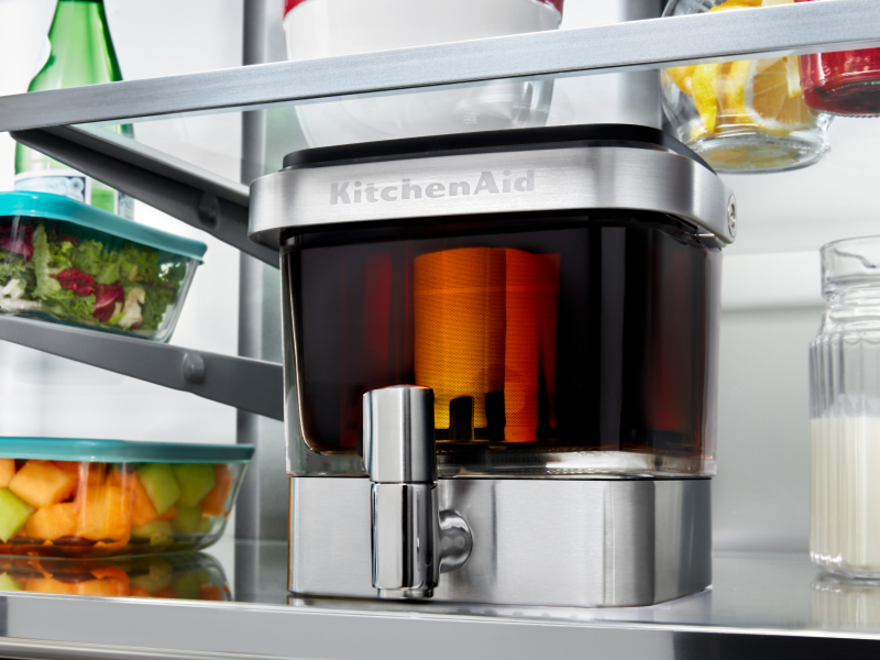 A filled KitchenAid® cold brew maker in a fridge