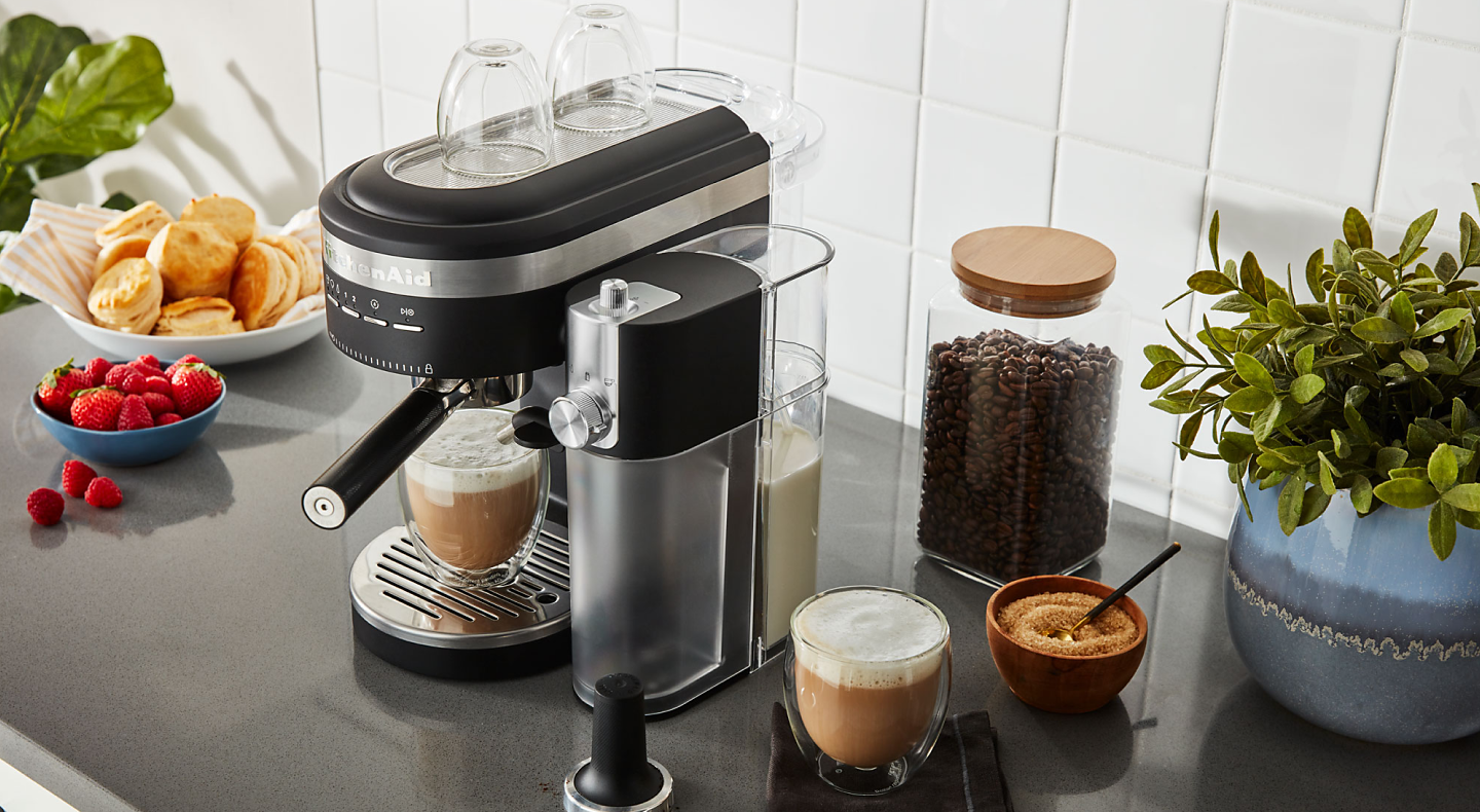 Espresso machine and milk frother on countertop with café style drinks