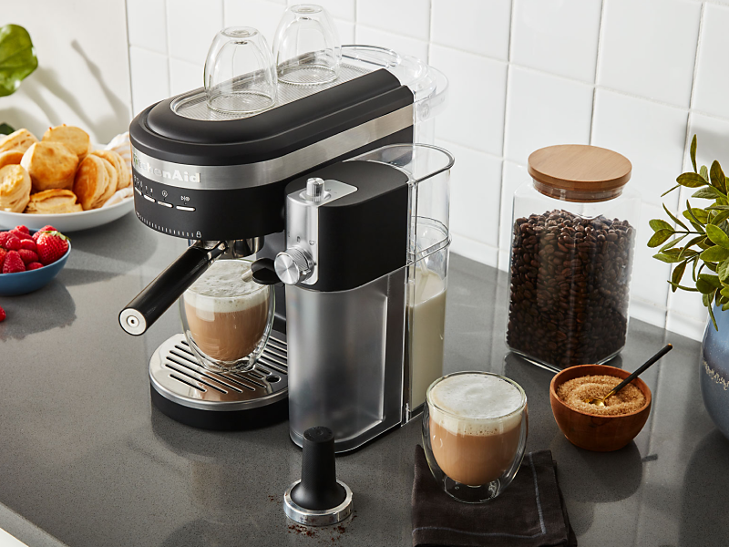Espresso machine and milk frother on countertop with café style drinks