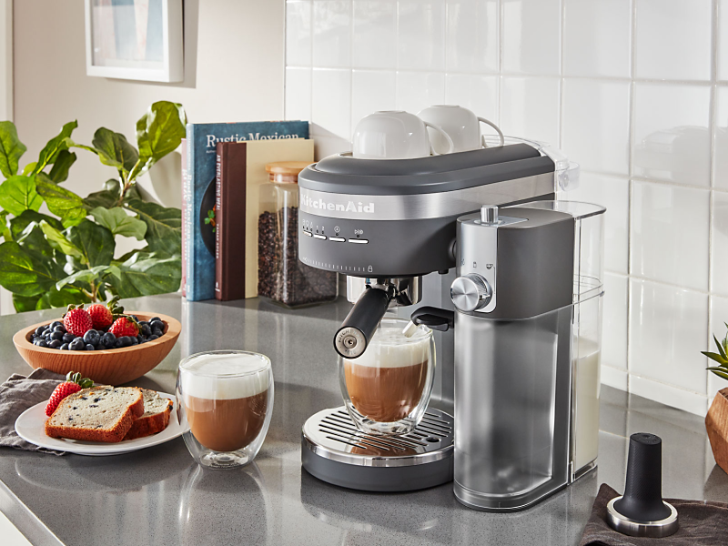 Espresso machine and lattes on countertop with breakfast items