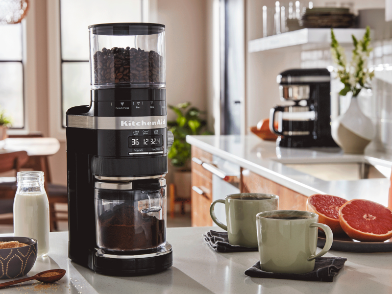 KitchenAid® coffee grinder next to two mugs