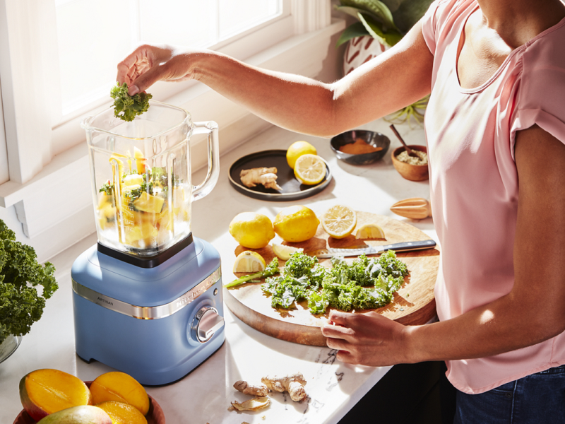 Lemons and herbs being added to KitchenAid® blender