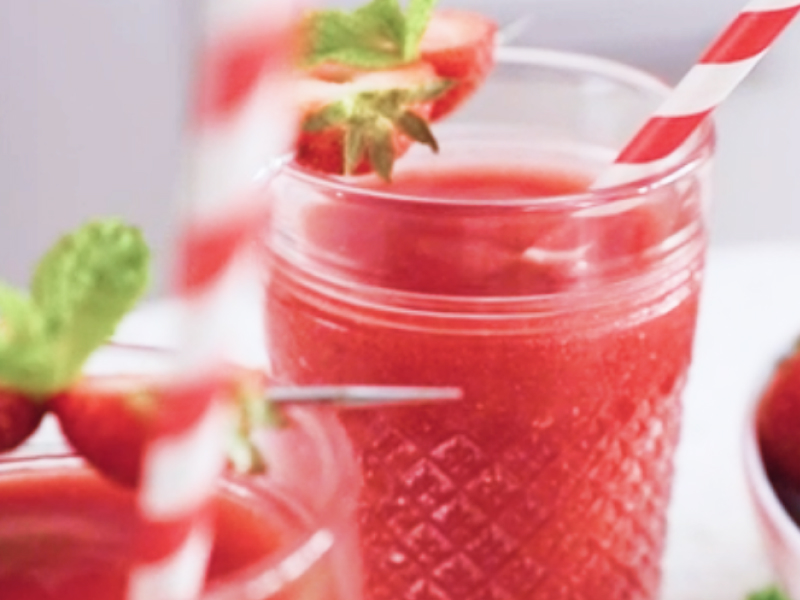 Frozen strawberry lemonade with red and white straws