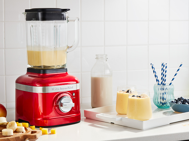 KitchenAid® blender next to tray with frozen fruit drinks