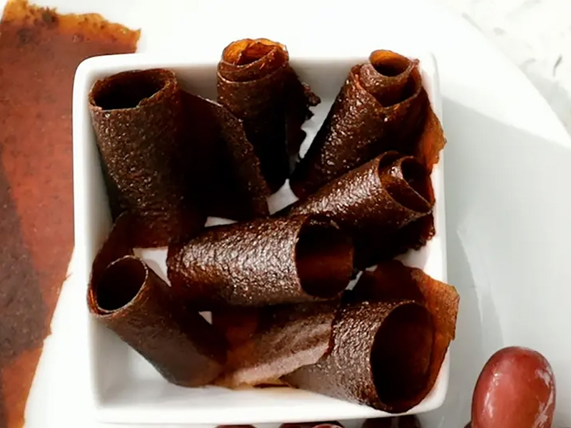 A dish of homemade rolled fruit leather.