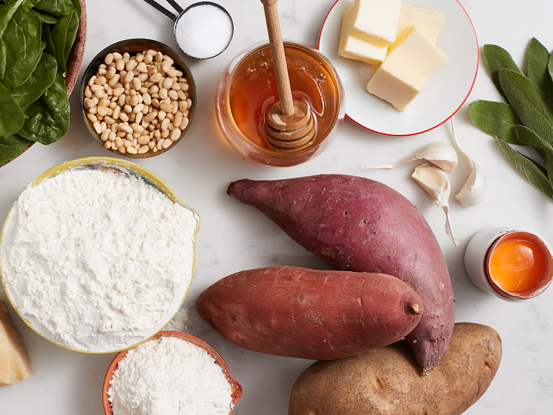 A kitchen counter with the ingredients for a sweet potato gnocchi recipe.